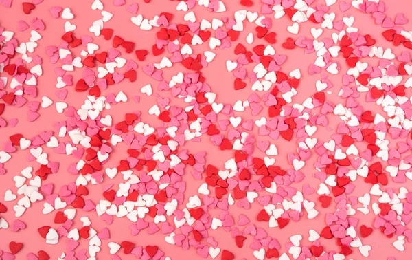 Romantic background with small hearts on pink background. The view from the top. — Stock Photo, Image