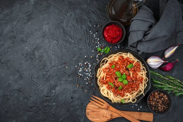 Pasta with meat garnish and basil spices.