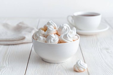 Bir peçete ve bir fincan çayla arka planda kremalı bir hayat. Yan görünüm, yatay.