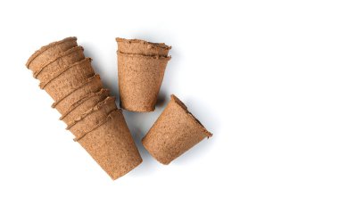 Beyaz arka planda fidanlar için boş turba kapları. Tarım kavramı.