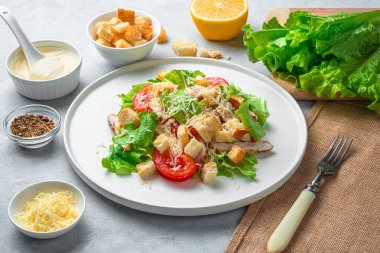 Taze, lezzetli Sezar salatası, sos, peynir ve salata. Yan görünüm, yatay.