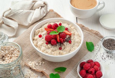 Hafif arkaplanlı yulaf lapalı kahvaltı. Sağlıklı yemek..