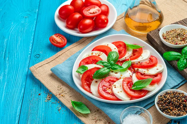 Caprese Sallad Med Tomater Och Mozzarella Ost Blå Bakgrund Sidovy — Stockfoto