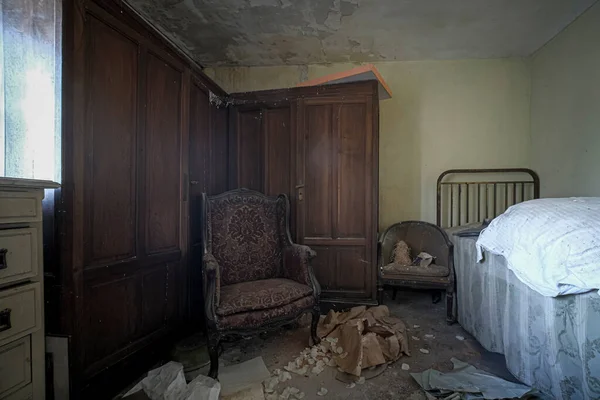 living room with sofa and armchairs in old abandoned house. High quality photo