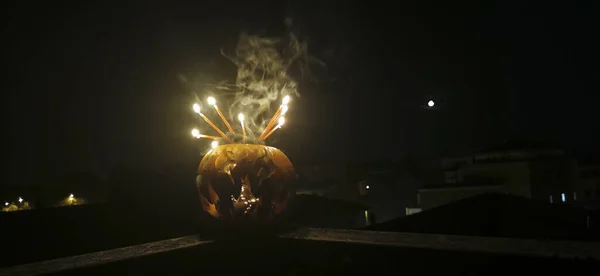 Halloween pumpkin cut out with face with burning candles. High quality photo