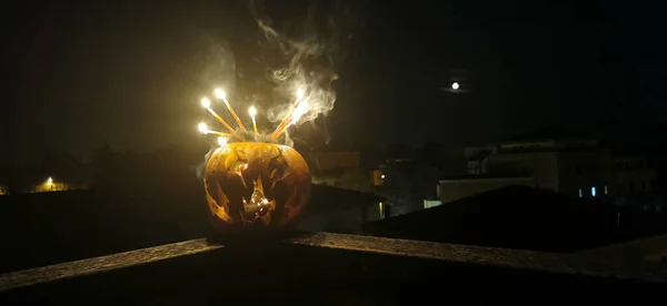 Halloween pumpkin cut out with face with burning candles. High quality photo