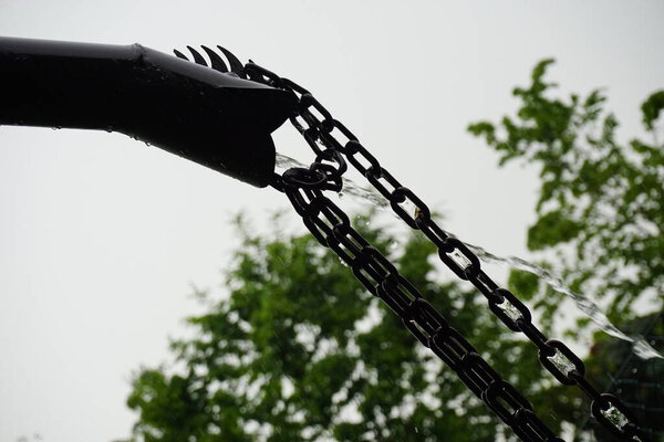 gutter with chain where water falls. High quality photo