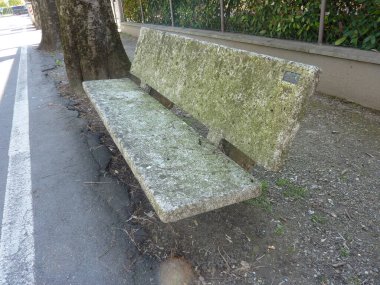 Old granite bench beside a road in the small town of Bibbiano, Reggio Emilia, Italy. High quality photo