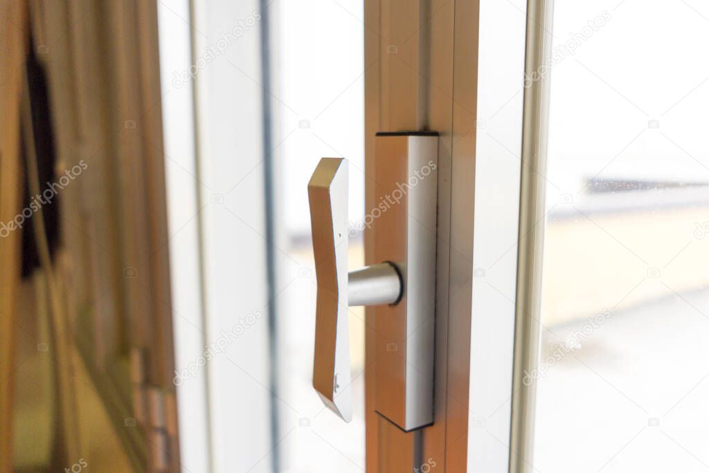 Detail of the metal handle of a French door. High quality photo