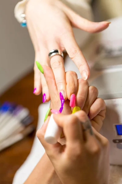 nail and hand treatment with nail polish application in the beauty salon. High quality photo