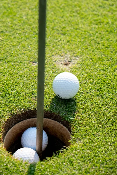 ball on the golf course near the hole. High quality photo