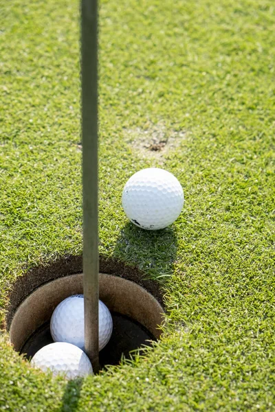 ball on the golf course near the hole. High quality photo