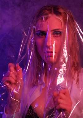 beautiful blonde italian girl posing in photo studio with colorful lights. High quality photo