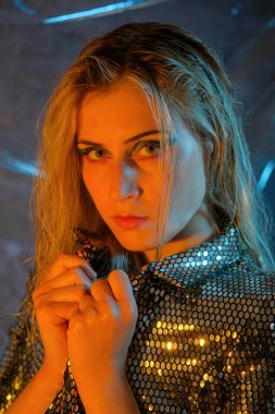 beautiful blonde italian girl posing in photo studio with colorful lights High quality photo
