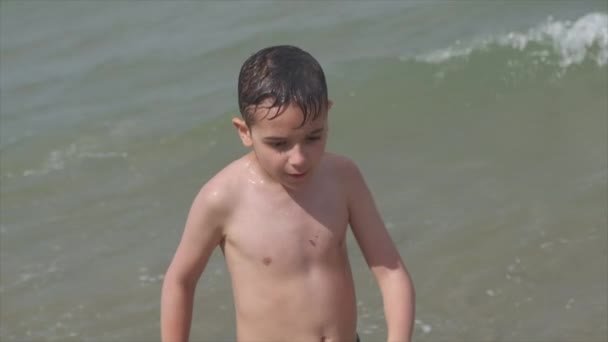 海の美しい子供はリミニ・リッチオーネの波で遊ぶイタリア — ストック動画