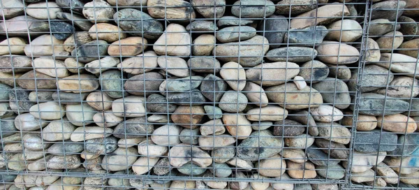 river rock walls in metal cages. High quality photo