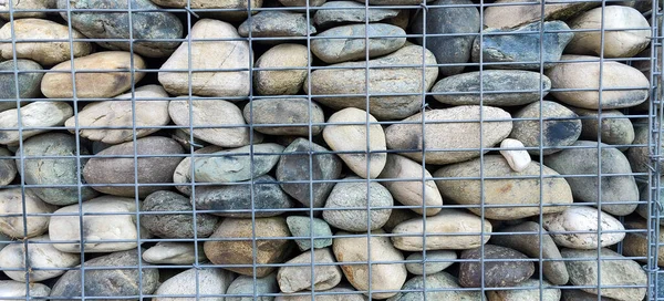 river rock walls in metal cages. High quality photo