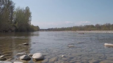 pebbles and stones in the river bed on sunny day enza