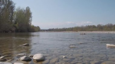 pebbles and stones in the river bed on sunny day enza