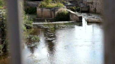 pebbles and stones in the river bed on sunny day enza