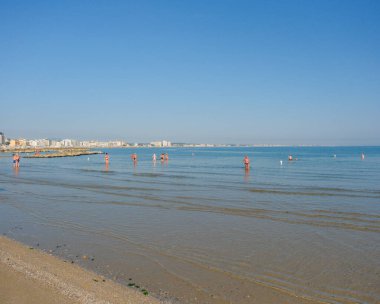 Cattolica 'da sakin bir Adriyatik kıyısı sığ suları ve açık mavi bir yaz gökyüzünün altında kumlu bir plajı var. Yüksek kalite fotoğraf