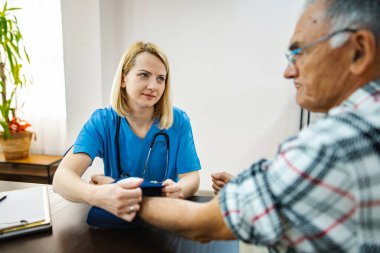 Hemşire ve kıdemli hasta sağlık ziyareti içindeler..