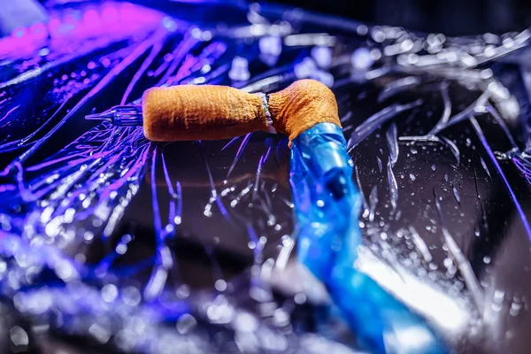 Cyberpunk tattoo parlor. Tattoo typewriter close-up and blue light.