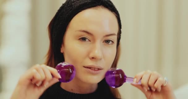 Женщина гладит по лицу ледяной глобус — стоковое видео