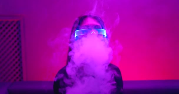 Un sacco di vapore dal vaporizzatore nella stanza al neon. Stile Cyberpunk. C'è un effetto di grano, rumore. — Video Stock