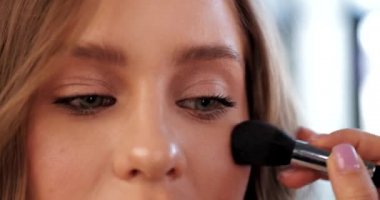 Güzellik salonunda yüz pudrası. Yakın çekim videosu.