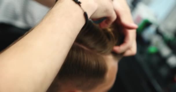 Barber styles his hair with wax and clay with his hands. — Stock Video