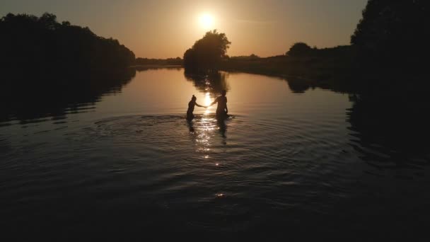 Pareja en río al atardecer romántico lugar — Vídeo de stock