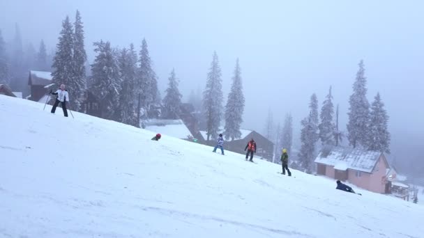 Драгобрат, январь - 13 января 2021 года: катание на лыжах и сноуборде по снежной горке — стоковое видео