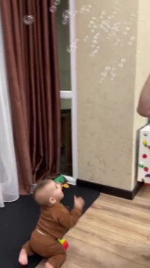 Baby Playing with Bubbles Indoors.