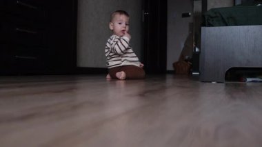 Baby Sitting on Floor with Yellow Ball.