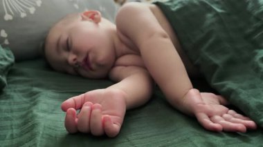 Peaceful Baby Sleeping Under Green Blanket Close up