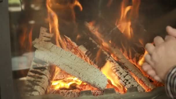 Warming hands by a fireplace. — Stock Video