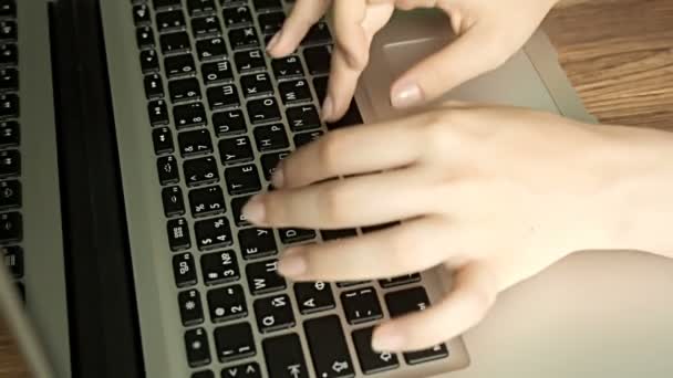 Mains féminines tapant sur le clavier de l'ordinateur