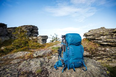 Sırt çantasında tripod ve dağ yürüyüşü sırasında yürüyüş direği var. Yürüyüş ve yürüyüş için açık hava ekipmanları