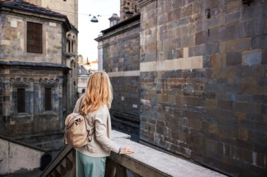 Solo traveler exploring medieval architecture of Basilica di Santa Maria Maggiore in Citta Alta Bergamo, Italy. City break in Europe