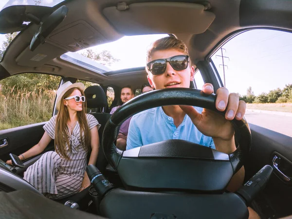 group of friends in car road trip concept