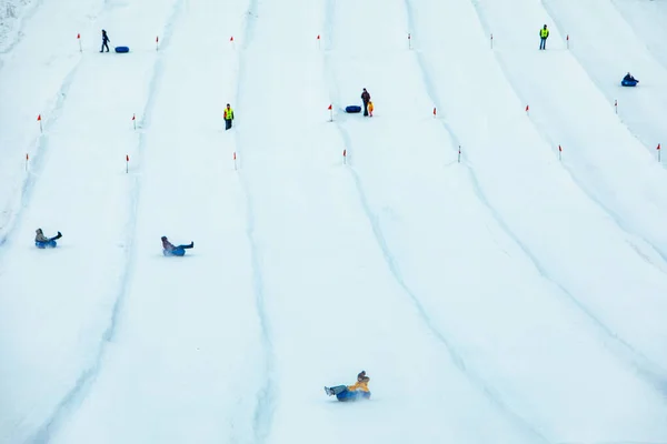 people having fun. snow tubing down by winter hill. winter time