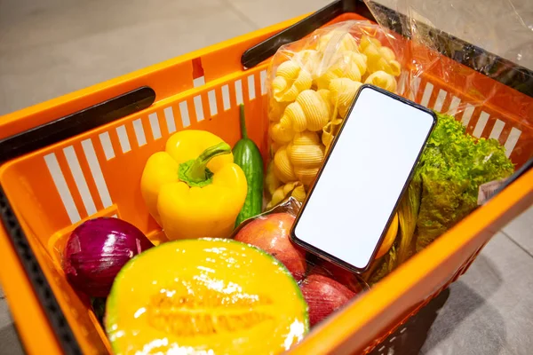 phone with white screen in grocery basket copy space