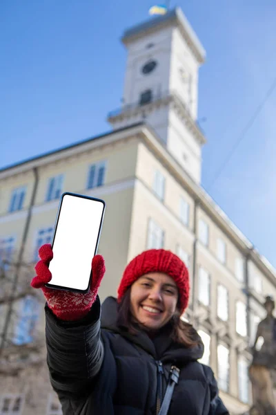 Человек Красной Зимней Шляпе Держит Телефон Белым Пустым Экраном Европейской — стоковое фото
