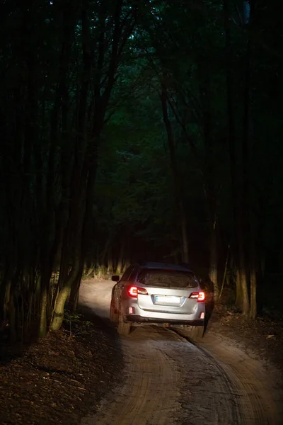 stock image suv car riding by trail road in forest night time