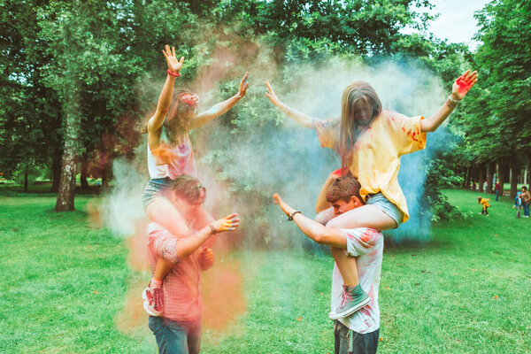 young happy friends at holi fest indian traditional holiday