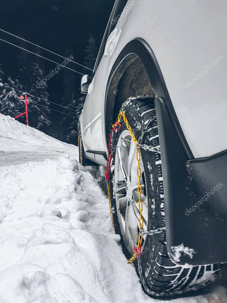 car wheels in chains close up snowed road copy space