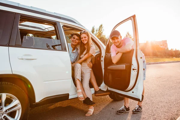 Amigos Posando Perto Carro Pôr Sol Conceito Viagem Rodoviária — Fotografia de Stock