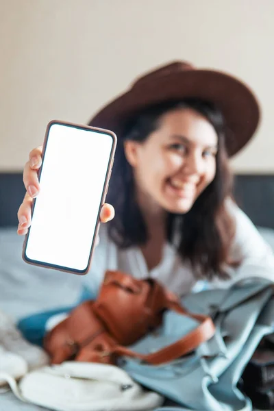 woman holding phone with white screen and bank credit card copy space