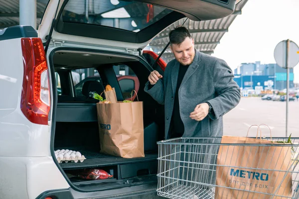Άνθρωπος Βάζοντας Τσάντες Προϊόν Στο Πορτ Μπαγκάζ Του Αυτοκινήτου Αντίγραφο — Φωτογραφία Αρχείου